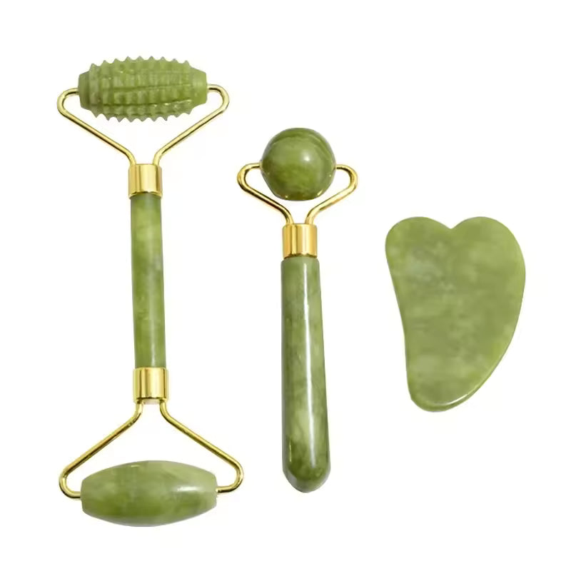 Set of green jade facial rollers and gua sha tool on a white background